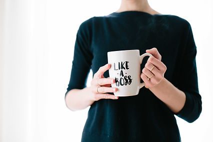 A woman holding a mug with the phrase "like a boss" on it - Katie Stone, Education Business Services